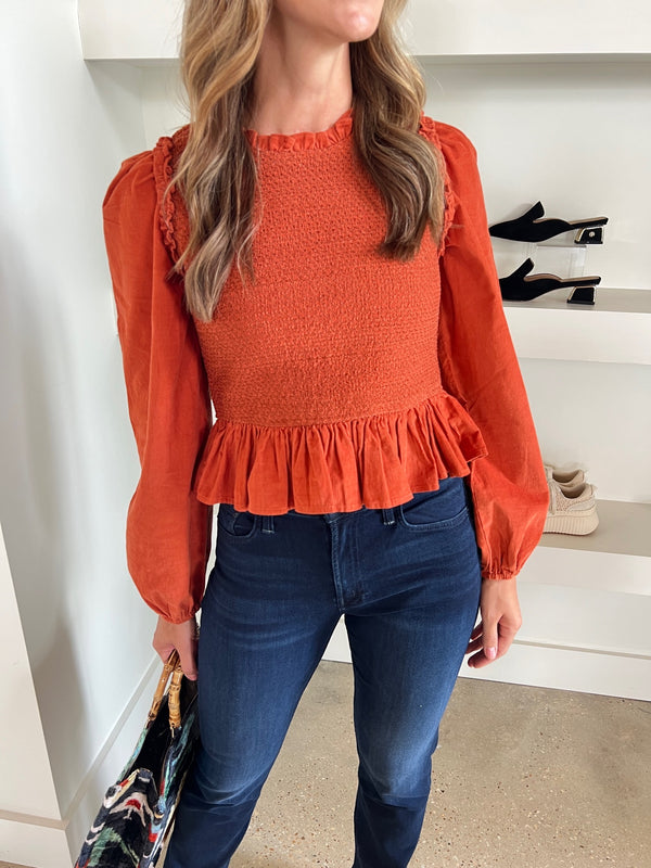 Rust Fiona Top by Love the Label featuring a fitted smocked bodice and corduroy sleeves, a stylish and textured fashion piece.